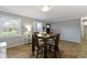 Inviting dining area featuring wood flooring, natural light from multiple windows, and classic decor at 10421 Hillsdale Dr, Carmel, IN 46032