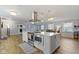 Modern kitchen with stainless steel appliances, custom range hood and a large island at 10421 Hillsdale Dr, Carmel, IN 46032