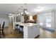 Eat in kitchen features stainless steel appliances, granite countertops, bar seating and wood floors at 10421 Hillsdale Dr, Carmel, IN 46032