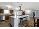 Spacious kitchen featuring a large island, wood floors, stainless steel appliances, and stone fireplace at 10421 Hillsdale Dr, Carmel, IN 46032
