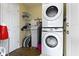 Laundry room featuring a stacked washer and dryer with shelving at 10421 Hillsdale Dr, Carmel, IN 46032