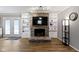Cozy living room with a stone fireplace, custom built-ins and hardwood floors at 10421 Hillsdale Dr, Carmel, IN 46032