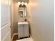 Bathroom featuring a gray vanity, modern lighting, and neutral walls at 106 S Wayburn St, Indianapolis, IN 46229