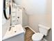 Bathroom with a neo-angle shower, modern sink, mirror and gray color scheme at 106 S Wayburn St, Indianapolis, IN 46229