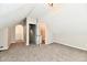 Finished attic with neutral paint and carpet with a walk in closet and adjacent bathroom at 106 S Wayburn St, Indianapolis, IN 46229