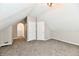 Finished attic with neutral paint and carpet with a walk in closet and adjacent bathroom at 106 S Wayburn St, Indianapolis, IN 46229