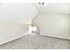 Unfurnished bedroom with carpet, a vaulted ceiling, and natural light from a small window at 106 S Wayburn St, Indianapolis, IN 46229