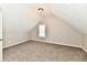 Finished attic area with neutral paint and carpet with a window for natural light at 106 S Wayburn St, Indianapolis, IN 46229