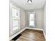 Bedroom with two windows providing ample natural light, neutral walls, and wood-look floors at 106 S Wayburn St, Indianapolis, IN 46229