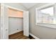 Bedroom with gray walls, wood-look floors, and a bifold closet at 106 S Wayburn St, Indianapolis, IN 46229