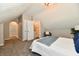 Bright bedroom with ensuite, carpet flooring, and walk-in closet space for ample storage at 106 S Wayburn St, Indianapolis, IN 46229