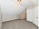 Finished attic area with neutral paint and carpet and a door to another finished area at 106 S Wayburn St, Indianapolis, IN 46229