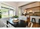 Open dining area with view to kitchen and natural light at 106 S Wayburn St, Indianapolis, IN 46229