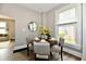 Bright dining area featuring a round table with seating for four and a large window at 106 S Wayburn St, Indianapolis, IN 46229