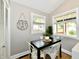 Cozy dining nook featuring a dark table, white chairs, and lots of natural light at 106 S Wayburn St, Indianapolis, IN 46229