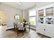 Cozy dining area with wood-look floors, a round table, and a built-in china cabinet at 106 S Wayburn St, Indianapolis, IN 46229