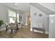 Cozy dining area with seating for four, a built-in cabinet, and natural light at 106 S Wayburn St, Indianapolis, IN 46229