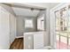 Sunlit entryway with neutral paint, wood-look floors, closet, and door to the outdoors at 106 S Wayburn St, Indianapolis, IN 46229