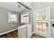 Neutral entryway boasts wood-look floors, two windows, and a door with glass panels at 106 S Wayburn St, Indianapolis, IN 46229