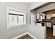 Sunlit entry features white trim windows and an exterior door leading to the kitchen at 106 S Wayburn St, Indianapolis, IN 46229