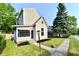 Charming two-story home with a well-maintained lawn and inviting curb appeal on a sunny day at 106 S Wayburn St, Indianapolis, IN 46229