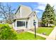 Charming two-story home with a well-maintained lawn and mature trees offering curb appeal at 106 S Wayburn St, Indianapolis, IN 46229