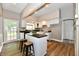 Modern kitchen with a central island, bar stool seating, and white cabinets at 106 S Wayburn St, Indianapolis, IN 46229