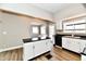 Updated kitchen with white cabinets, black countertops, and hardwood floors at 106 S Wayburn St, Indianapolis, IN 46229
