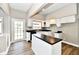Updated kitchen with white cabinetry, black countertops, and stainless-steel appliances at 106 S Wayburn St, Indianapolis, IN 46229