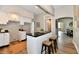 Stylish kitchen featuring white cabinets, dark countertops, and a central island with seating at 106 S Wayburn St, Indianapolis, IN 46229