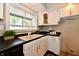 Charming kitchen featuring white cabinets, sleek countertops, and a bright window at 106 S Wayburn St, Indianapolis, IN 46229