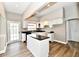 Updated kitchen featuring white cabinets, island and modern lighting at 106 S Wayburn St, Indianapolis, IN 46229
