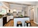 Contemporary kitchen with white cabinets, dark countertops, and a convenient kitchen island at 106 S Wayburn St, Indianapolis, IN 46229
