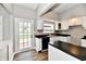 Well-lit kitchen with white cabinets and black countertops at 106 S Wayburn St, Indianapolis, IN 46229