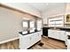 Well-lit kitchen with white cabinets, and updated appliances at 106 S Wayburn St, Indianapolis, IN 46229