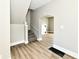 Spacious living room with hardwood floors, neutral paint, and staircase at 106 S Wayburn St, Indianapolis, IN 46229