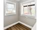 Sunlit living area features two windows with white trim and wood-look floors at 106 S Wayburn St, Indianapolis, IN 46229