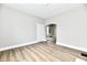 Bright room featuring neutral gray walls, hardwood-look flooring and an arched doorway at 106 S Wayburn St, Indianapolis, IN 46229