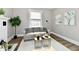 Well-lit living room with comfortable sofa, decorative accents, and a serene atmosphere at 106 S Wayburn St, Indianapolis, IN 46229
