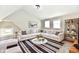 Staged living room featuring a large sectional sofa, decorative rug, and neutral decor at 106 S Wayburn St, Indianapolis, IN 46229
