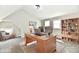 Staged home office features a desk, chair, bookshelf, and neutral decor under a vaulted ceiling at 106 S Wayburn St, Indianapolis, IN 46229