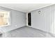 Enclosed sunroom featuring neutral gray walls and ceiling with carpet and access to the exterior at 106 S Wayburn St, Indianapolis, IN 46229