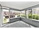 Bright sunroom with large windows offering ample natural light and views of the outdoors at 106 S Wayburn St, Indianapolis, IN 46229