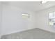 Bright bedroom with new carpeting, white walls, trim, and ample natural light from two windows at 109 S 10Th S Ave, Beech Grove, IN 46107
