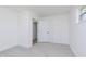 Clean, carpeted bedroom featuring fresh white paint, trim and paneled door detail at 109 S 10Th S Ave, Beech Grove, IN 46107