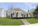 Inviting home with a black porch, light gray siding and lush green front lawn at 109 S 10Th S Ave, Beech Grove, IN 46107