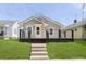Charming bungalow featuring a welcoming porch, light gray siding and manicured front lawn at 109 S 10Th S Ave, Beech Grove, IN 46107