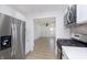Modern kitchen with stainless steel appliances, white cabinetry, and an open layout to the living area at 109 S 10Th S Ave, Beech Grove, IN 46107