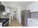 Modern kitchen featuring stainless steel appliances, white cabinets, and quartz countertops at 109 S 10Th S Ave, Beech Grove, IN 46107