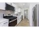 Modern kitchen with stainless steel appliances, white cabinets, and stylish backsplash at 109 S 10Th S Ave, Beech Grove, IN 46107